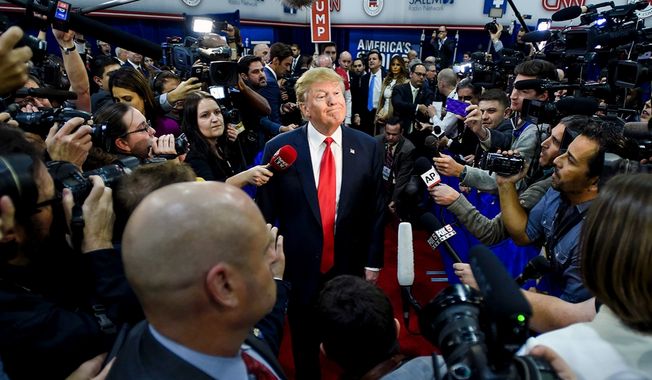 The Republican presidential hopeful Doanld Trump is surrounded by the news media while on the campaign trail in 2016, seen here in a stop in Las Vegas, Nev.    (Associated Press)