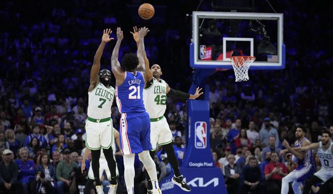 Philadelphia 76ers&#x27; Joel Embiid (21) goes up to shoot against Boston Celtics&#x27; Jaylen Brown (7) and Al Horford (42) during overtime of Game 4 in an NBA basketball Eastern Conference semifinals playoff series, Sunday, May 7, 2023, in Philadelphia. (AP Photo/Matt Slocum)