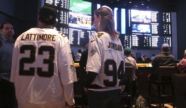 Customers at the Ocean Casino Resort in Atlantic City N.J. on Sept. 9, 2018, await the kickoff of the first NFL season after a US Supreme Court ruling clearing the way for legal sports betting. Americans have bet over $220 billion on sports with legal gambling outlets in the five years since that ruling. (AP Photo/Wayne Parry, File)