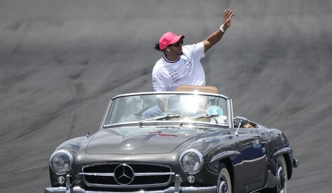 Mercedes driver Lewis Hamilton (44) of Team Great Britain waves to the crowd during the drivers&#x27; parade before the Formula One Miami Grand Prix auto race at the Miami International Autodrome, Sunday, May 7, 2023, in Miami Gardens, Fla. (AP Photo/Wilfredo Lee) **FILE**