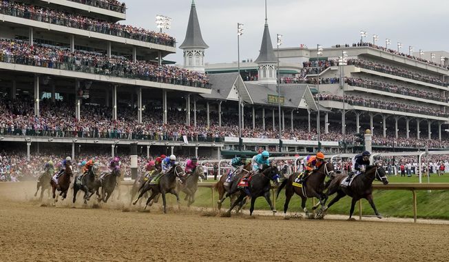 Horses come through the first turn during the 149th running of the Kentucky Derby horse race at Churchill Downs Saturday, May 6, 2023, in Louisville, Ky. (AP Photo/Julio Cortez)