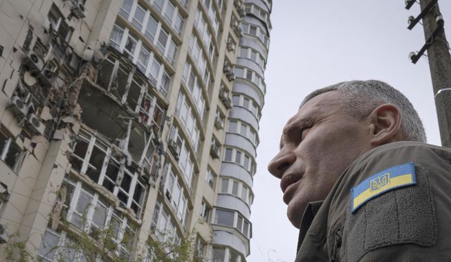 Kyiv Mayor Vitali Klitschko stands in front of an apartment building damaged by a drone that was shot down during a Russian overnight strike, amid Russia&#x27;s attack, in Kyiv, Ukraine, Monday, May 8, 2023. (AP Photo/Andrew Kravchenko)