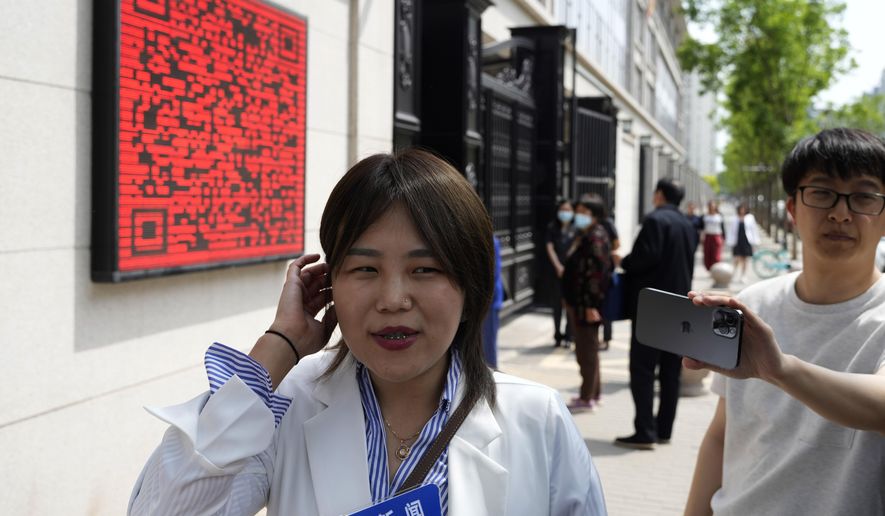 Teresa Xu speaks to journalists before her appeal hearing in Beijing, Tuesday, May 9, 2023. The unmarried Chinese woman on Tuesday began her final appeal of a hospital's denial of access to freeze her eggs five years ago in a landmark case of female reproductive rights in the country. (AP Photo/Ng Han Guan)