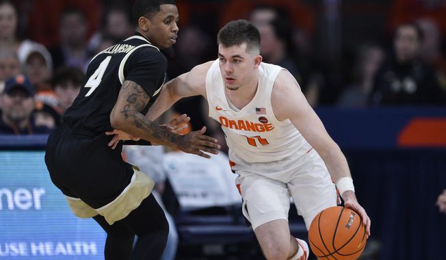 Syracuse guard Joseph Girard III, right, drives against Wake Forest guard Daivien Williamson during the second half of an NCAA college basketball game in Syracuse, N.Y., Saturday, March 4, 2023. Clemson has added four transfers including high-scoring, ex-Syracuse player Joseph Girard III to its men&#x27;s basketball roster for next season. The school announced Tuesday, May 9, that Girard, former North Carolina State forward Jack Clark, ex-Air Force guard Jake Heidbreder and former UNC Greensboro forward Bas Leyte all signed with the Tigers for next season. (AP Photo/Adrian Kraus) **FILE**