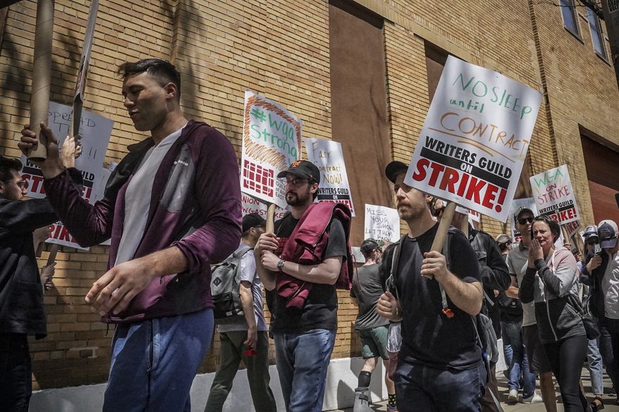 Striking members and supporters of the Writers Guild of America walk the picket line during a rally outside Silvercup Studios, Tuesday May 9, 2023, in New York. (AP Photo/Bebeto Matthews) **FILE**