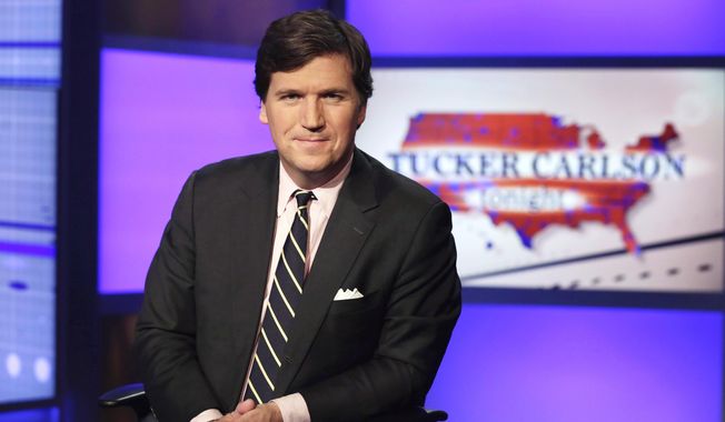 FILE - Tucker Carlson, host of &quot;Tucker Carlson Tonight,&quot; poses for photos in a Fox News Channel studio on March 2, 2017, in New York. Fired Fox news host Carlson said Tuesday, May 9, 2023, that he will be putting out a “new version” of his program on Twitter. (AP Photo/Richard Drew, File)