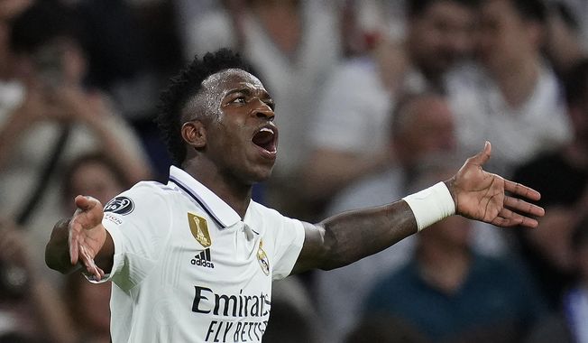 Real Madrid&#x27;s Vinicius Junior celebrates after scoring the opening goal during the Champions League semifinal first leg soccer match between Real Madrid and Manchester City at the Santiago Bernabeu stadium in Madrid, Spain, Tuesday, May 9, 2023. (AP Photo/Manu Fernandez)