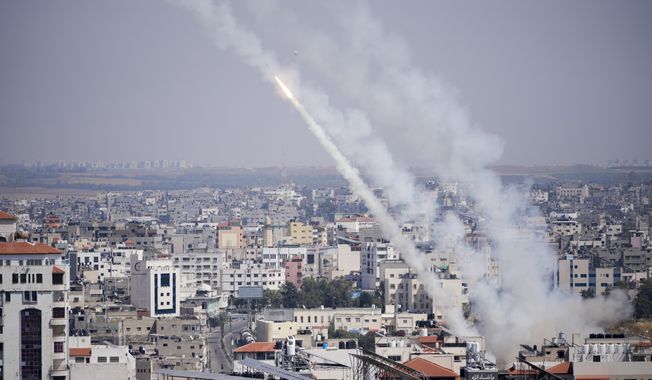 Rockets are launched from the Gaza Strip towards Israel, in Gaza, Wednesday, May 10, 2023. Palestinian militants fired dozens of rockets from the Gaza Strip into Israel on Wednesday, in a first response to Israeli airstrikes that have killed 16 Palestinians, including three senior militants and at least 10 civilians. (AP Photo/Hatem Moussa)