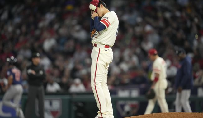 Los Angeles Angels starting pitcher Shohei Ohtani (17) adjusts his cap during the fifth inning of a baseball game against the Houston Astros in Anaheim, Calif., Tuesday, May 9, 2023. (AP Photo/Ashley Landis)