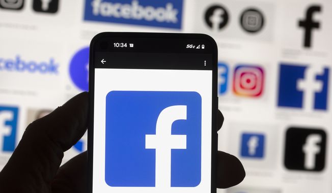 The Facebook logo is seen on a cell phone, Friday, Oct. 14, 2022, in Boston. A Delaware judge on Wednesday, May 10, 2023, refused to dismiss a shareholder lawsuit alleging that Facebook officers and directors violated both the law and their fiduciary duties in failing for years to protect the privacy of user data. (AP Photo/Michael Dwyer) **FILE**