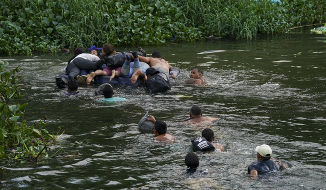 Migrants cross the Rio Bravo into the United States from Matamoros, Mexico, Tuesday, May 9, 2023. The U.S. is preparing for the Thursday, May 11th end of the Title 42 policy, linked to the coronavirus pandemic that allowed it to quickly expel many migrants seeking asylum. (AP Photo/Fernando Llano)