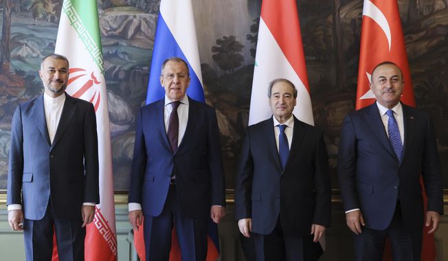 In this handout photo released by Russian Foreign Ministry Press Service, Iran&#x27;s Foreign Minister Hossein Amirabollahian, left, Russia&#x27;s Foreign Minister Sergey Lavrov, second left, Syria&#x27;s Foreign Minister Faisal Mekdad, second right, and Turkey&#x27;s Foreign Minister Mevlut Cavusoglu pose for a photo prior to their talks during the foreign ministers of Russia, Syria, Turkey, and Iran meeting in Moscow, Russia, Wednesday, May 10, 2023.(Russian Foreign Ministry Press Service via AP)