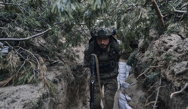 A Ukrainian soldier goes in a trench close to the Russian positions near Kremenna in the Luhansk region, Ukraine, Tuesday, May 9, 2023. (AP Photo/LIBKOS)