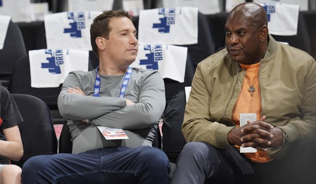 Phoenix Suns owner Mat Ishbia, left, sits with Michigan State head football coach Mel Tucker as players warm up before Game 5 of an NBA basketball second-round playoff series against the Denver Nuggets Tuesday, May 9, 2023, in Denver. (AP Photo/David Zalubowski)