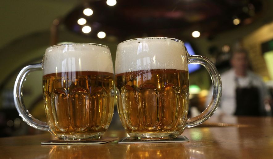 Glasses of beer lie on a table in a pub in Prague, Czech Republic, on Feb. 2, 2016. (AP Photo/Petr David Josek/File) **FILE**