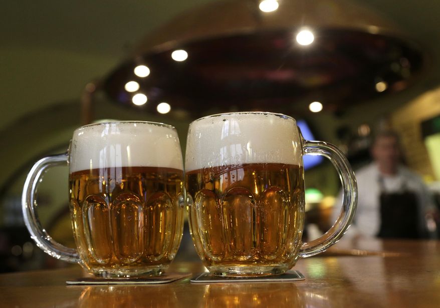 Glasses of beer lie on a table in a pub in Prague, Czech Republic, on Feb. 2, 2016. (AP Photo/Petr David Josek/File) **FILE**