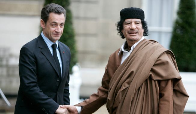In this Dec. 10 2007, photo, French President Nicolas Sarkozy, left, greets Libyan leader Col. Moammar Gadhafi upon his arrival at the Elysee Palace, in Paris. French prosecutors are seeking to send former President Nicolas Sarkozy to trial on charges that he received millions in illegal campaign financing from the regime of late Libyan leader Moammar Gadhafi. (AP Photo/Francois Mori) **FILE**