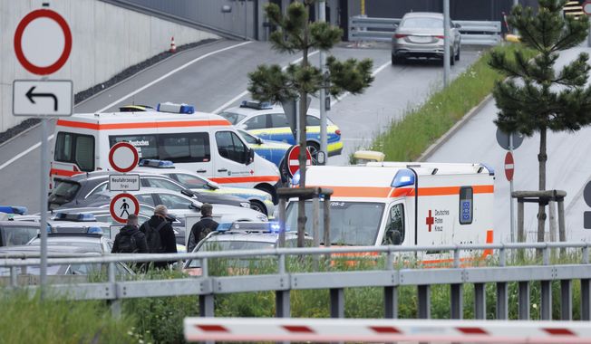 Police emergency vehicles are parked at a Mercedes-Benz plant in Sindelfingen, Germany, Thursday May 11, 2023. A man opened fire at a Mercedes-Benz factory in southwestern Germany on Thursday, German prosecutors confirmed. (Julian Rettig/dpa via AP)