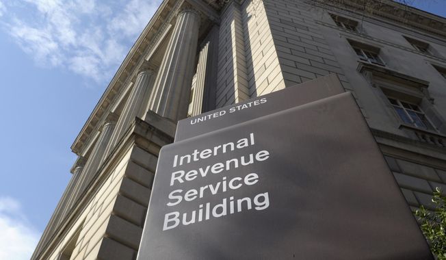 The exterior of the Internal Revenue Service (IRS) building in Washington, on March 22, 2013. In an effort to stop personal threats aimed at IRS employees, the agency says it will start limiting the workers’ personal identifying information on communications with taxpayers. (AP Photo/Susan Walsh, File)