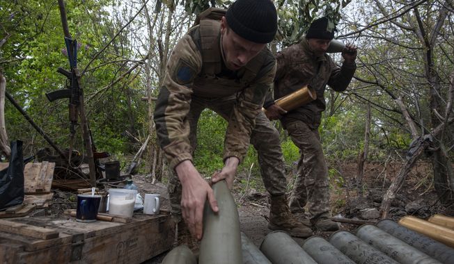 Ukrainian soldiers prepare self-propelled howitzer shells in Chasiv Yar, the site of heavy battles with the Russian forces in the Donetsk region, Ukraine, Thursday, May 11, 2023. (Iryna Rybakova via AP)