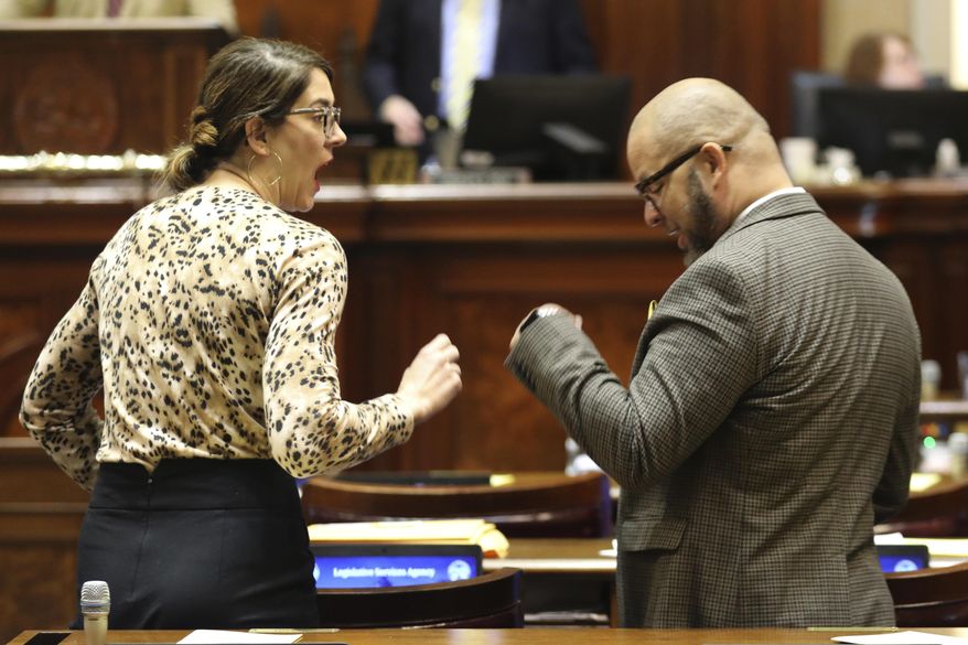 South Carolina Rep. Heather Bauer, D-Columbia, left, and Rep. John King, D-Rock Hill, right talk before the House session begins on Thursday, May 11, 2023, in Columbia, S.C. (AP Photo/Jeffrey Collins)