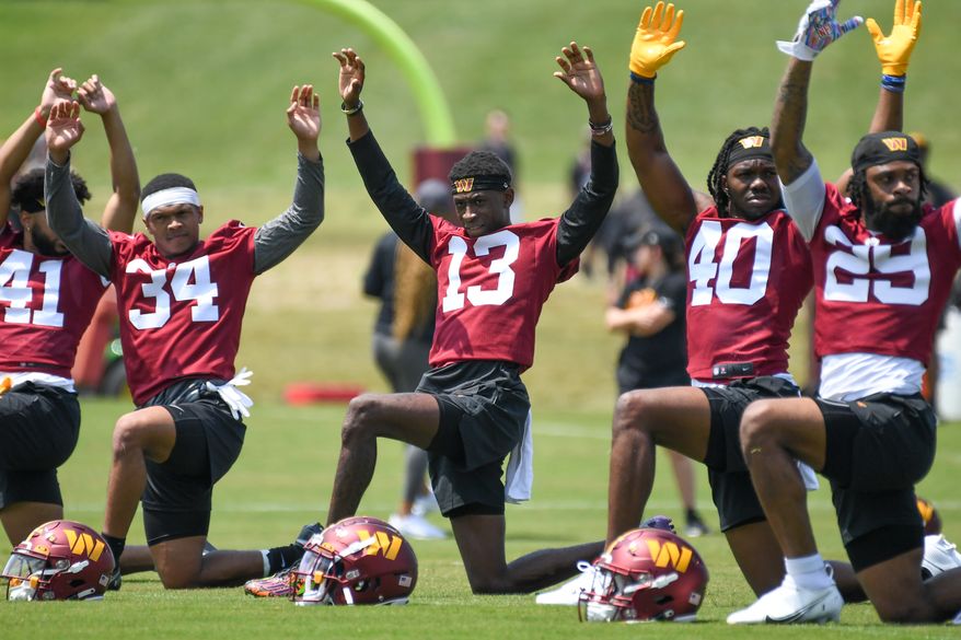 Washington Commanders first-round draft pick Emmanuel Forbes, Jr. (13) stretching on the field during Rookie Mini-Camp at the team's training facility in Ashburn, VA, May 12, 2023. (Photo by Billy Sabatini)