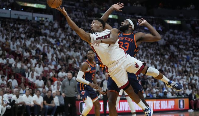 Miami Heat guard Kyle Lowry goes up for a shot against New York Knicks center Mitchell Robinson (23) during the second half of Game 6 of an NBA basketball second-round playoff series, Friday, May 12, 2023, in Miami. (AP Photo/Wilfredo Lee)