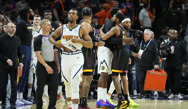 Denver Nuggets and Phoenix Suns players greet each other are Game 6 of an NBA basketball Western Conference semifinal game, Thursday, May 11, 2023, in Phoenix. The Nuggets eliminated the Sun in their 125-100 win. (AP Photo/Matt York)