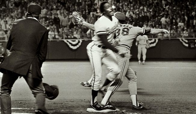 Umpire Don Denkinger, left, watches as St. Cardinals pitcher Todd Worrell, right, stretches to catch the ball as Kansas City Royals batter Jorge Orta steps on first base during the ninth inning in Game 6 of baseball&#x27;s World Series in Kansas City, Mo., Oct. 26, 1985. Denkinger ruled Orta safe and the Royals went on to win the game and eventually the World Series. (Patrick Sullivan/The Kansas City Star via AP, File)