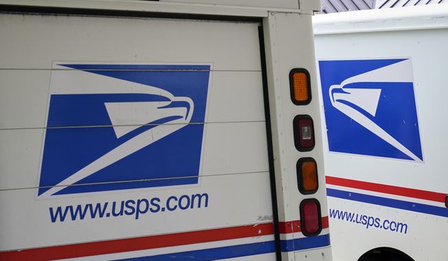 In this Aug. 18, 2020, photo, mail delivery vehicles are parked outside a post office in Boys Town, Neb. The U.S. Postal Service is replacing tens of thousands of antiquated keys used by postal carriers and installing thousands of high-security collection boxes to stop a surge in robberies and mail thefts, officials said Friday, May 12, 2023. (AP Photo/Nati Harnik, File)