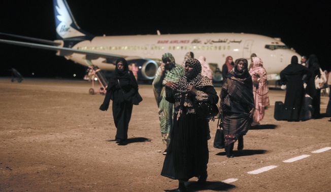 Sudanese, who had been stranded in Jeddah, Saudi Arabia, arrive at Port Sudan airport, Thursday, May 11, 2023. The conflict between the country&#x27;s military and a rival paramilitary group has killed hundreds and displaced hundreds of thousands since it broke out in mid-April, creating a humanitarian crisis inside the country and at its borders. (AP Photo/Amr Nabil)