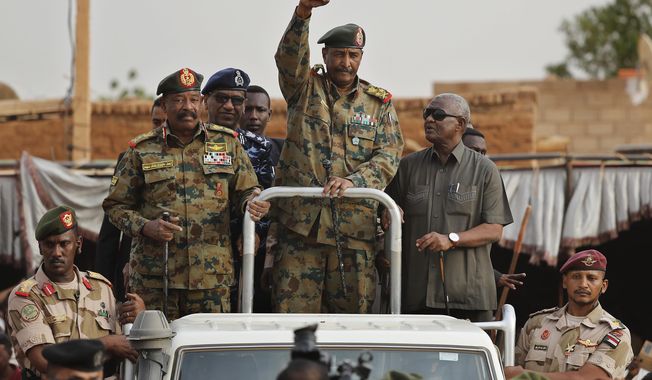 Sudanese Gen. Abdel-Fattah Burhan, head of the military council, waves to his supporters upon his arrival to attend a military-backed rally, in Omdurman district, west of Khartoum, Sudan, Saturday, June 29, 2019.(AP Photo/Hussein Malla, File)