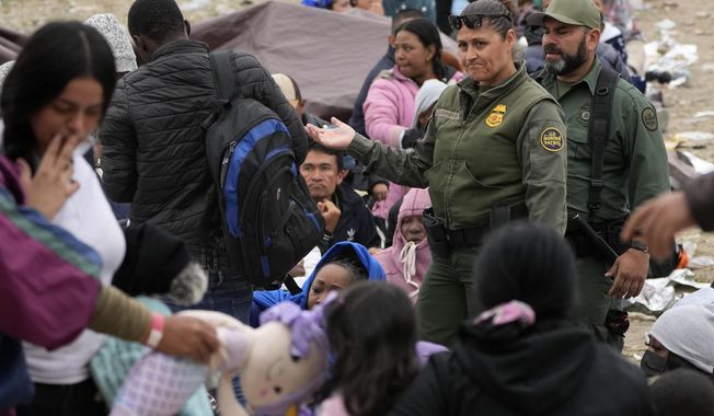 U.S. Border Patrol agents move through a crowd of migrants that have waited between two border walls for days to apply for asylum, as they decide who to take next to processing, Friday, May 12, 2023, in San Diego. Hundreds of migrants remain waiting between the two walls, many for days. The U.S. entered a new immigration enforcement era Friday, ending a three-year-old asylum restriction and enacting a set of strict new rules that the Biden administration hopes will stabilize the U.S.-Mexico border and push migrants to apply for protections where they are, skipping the dangerous journey north. (AP Photo/Gregory Bull) **FILE**