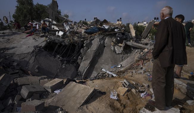 Palestinians inspect the rubble of a house after it was struck by an Israeli airstrike in Beit Lahia, northern Gaza Strip, Friday, May 12, 2023. On the fourth day of fighting between Israel and Islamic Jihad, the second-largest militant group in Gaza.(AP Photo/Fatima Shbair)