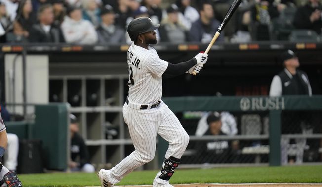 Chicago White Sox&#x27;s Luis Robert Jr. watches his home run during the fourth inning of the team&#x27;s baseball game against the Houston Astros on Saturday, May 13, 2023, in Chicago. (AP Photo/Erin Hooley)