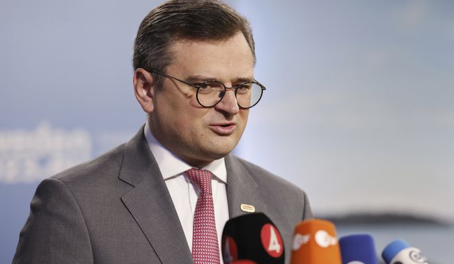 Ukrainian Foreign Minister Dmytro Kuleba speaks to the media with Swedish Foreign Minister Tobias Billstrom on the occasion of an informal meeting of EU foreign affairs ministers, in Marsta, outside Stockholm, on Saturday, May 13, 2023. (Christine Olsson/TT News Agency via AP)