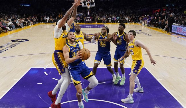 Golden State Warriors guard Stephen Curry (30) drives to the basket against the Los Angeles Lakers during the second half in Game 6 of an NBA basketball Western Conference semifinal series Friday, May 12, 2023, in Los Angeles. (AP Photo/Ashley Landis)