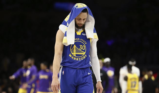 Golden State Warriors guard Stephen Curry stands during a timeout in the second quarter in Game 6 of the team&#x27;s NBA basketball Western Conference semifinal against the Los Angeles Lakers on Friday, May 12, 2023, in Los Angeles. (Santiago Mejia/San Francisco Chronicle via AP)