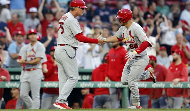 St. Louis Cardinals&#x27; Nolan Arenado (28) celebrates after his two-run home run with third base coach Ron &#x27;Pop&#x27; Warner (75) during the first inning of a baseball game against the Boston Red Sox, Friday, May 12, 2023, in Boston. (AP Photo/Michael Dwyer)