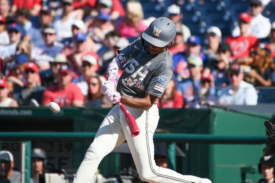 Washington Nationals shortstop C.J. Abrams (5) hitting a double during the second inning of an MLB game against the New York Mets at Nationals Park in Washington D.C., May 14, 2023. (Photo by Billy Sabatini/All-Pro Reels)