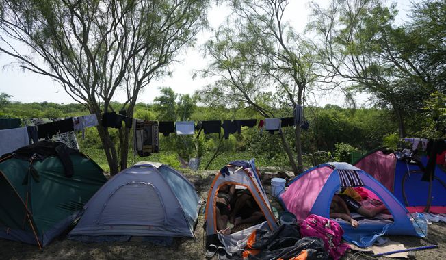 Venezuelan migrants rest inside their tents on the bank of the Rio Grande in Matamoros, Mexico, Sunday, May 14, 2023. As the U.S. ended its pandemic-era immigration restrictions, migrants are adapting to new asylum rules and legal pathways meant to discourage illegal crossings. (AP Photo/Fernando Llano)