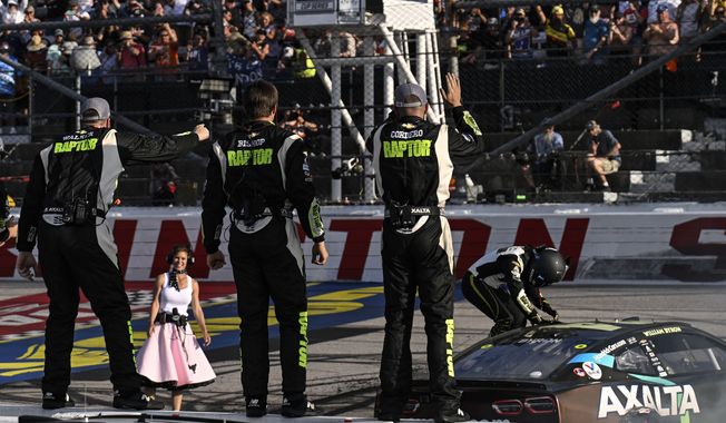 William Byron, right, climbs out of his car as his pit crew celebrates behind him after winning a NASCAR Cup Series auto race at Darlington Raceway, Sunday, May 14, 2023, in Darlington, S.C. (AP Photo/Matt Kelley)