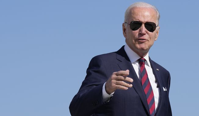 President Joe Biden answers a reporter&#x27;s question as he boards Air Force One at Dover Air Force Base in Dover, Del., Monday, May 15, 2023. Biden is traveling to Philadelphia. (AP Photo/Patrick Semansky)