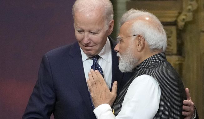 U.S. President Joe Biden, left, and India Prime Minister Narendra Modi talks during the G20 leaders summit in Nusa Dua, Bali, Indonesia, Nov. 15, 2022. Biden has made it a mission for the U.S. to build friendships overseas, and the next few weeks will offer a vivid demonstration of the importance he’s placing on a relationship with Modi. (AP Photo/Dita Alangkara, Pool, File)