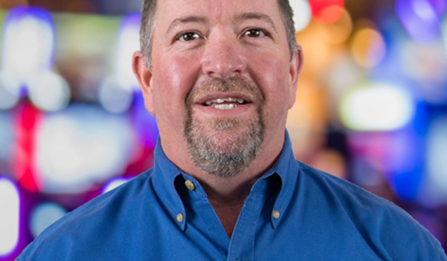This photo provided by Shaffer Distributing in May 2023, shows Marty Turner, director of vending sales for the company. Vending machines that have long been stocked with snacks are getting repurposed to distribute life-saving supplies to help fight the opioid epidemic. A growing number of cities and local governments are making so-called “harm reduction” items, including the overdose-reversal drug naloxone, available for free via machines. (Shaffer Distributing via AP)