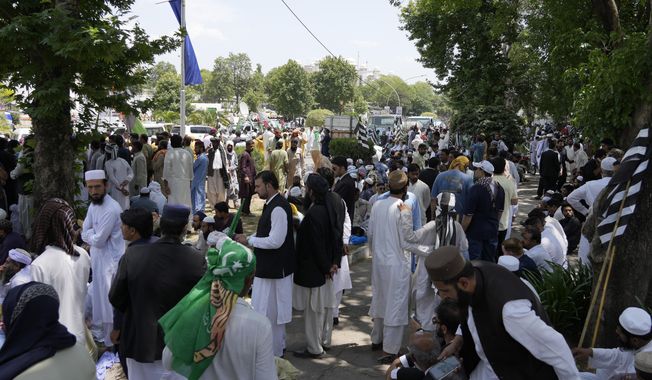 Supporters of Pakistan Democratic Movement, an alliance of the ruling political parties, take part in a rally outside the Supreme Court in Islamabad, Pakistan, Monday, May 15, 2023. Convoys of buses and vehicles filled with Pakistani pro-government supporters are flooding the main road leading to the country&#x27;s capital on Monday to protest the release of former Prime Minister Imran Khan. (AP Photo/Anjum Naveed)