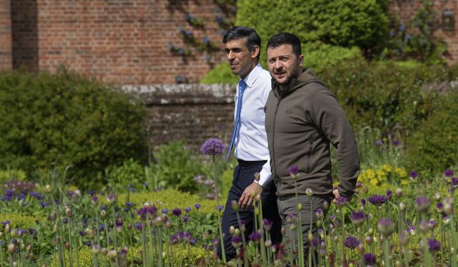 Britain&#x27;s Prime Minister Rishi Sunak, left, and Ukraine&#x27;s President Volodymyr Zelenskyy, walk in the garden at Chequers, the prime minister&#x27;s official country residence, in Aylesbury, England, Monday, May 15, 2023. Zelenskyy set off across Europe with a long shopping list. Ukraine’s president will head home with much of what he wanted – though not the Western fighter jets he seeks to defend against Russian air attacks. (Carl Court/Pool via AP)