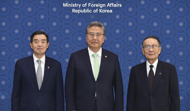 South Korean Foreign Minister Park Jin, center, poses for a photo with Mikio Sasaki, chairman of the Japan-Korea Economic Association, right, and Kim Yoon, chairman of the Korea-Japan Economic Association, left, ahead of their meeting at the Foreign Ministry in Seoul, South Korea, Monday, May 15, 2023. (Kim Min-Hee/Pool Photo via AP)