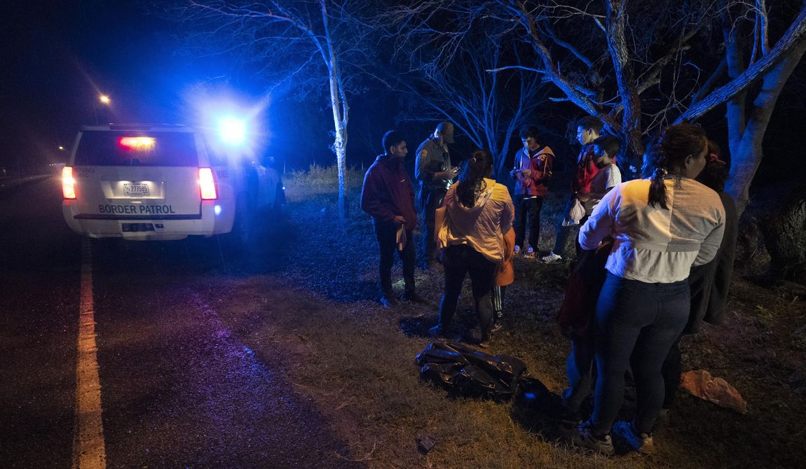 An immigration official stops a group of migrants from Central America as they walk on a road after they crossed the Texas-Mexico border, Friday, May 12, 2023, in Fronton, Texas. (AP Photo/Julio Cortez) ** FILE **