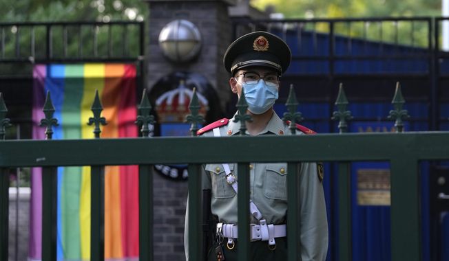 A Chinese paramilitary policemen stands guard outside the Swedish embassy during the opening ceremony for Diversity Week in Beijing, Friday, May 12, 2023. On Monday, May 15, 2023, the advocacy group the Beijing LGBT Center became the latest organization to close under a crackdown by Chinese leader Xi Jinping&#x27;s government. (AP Photo/Ng Han Guan)
